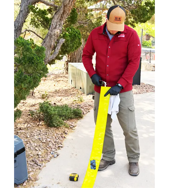 Technician preparing a CIPP pipe liner for trenchless sewer repair in El Paso