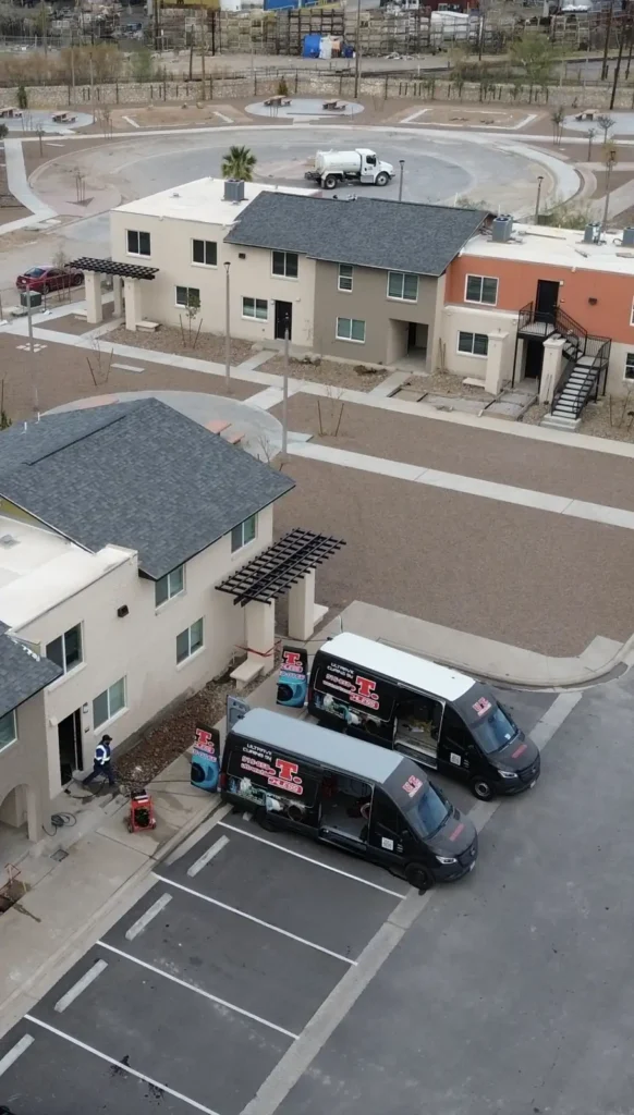 Aerial view of U.T. Trenchless vans at an El Paso apartment community